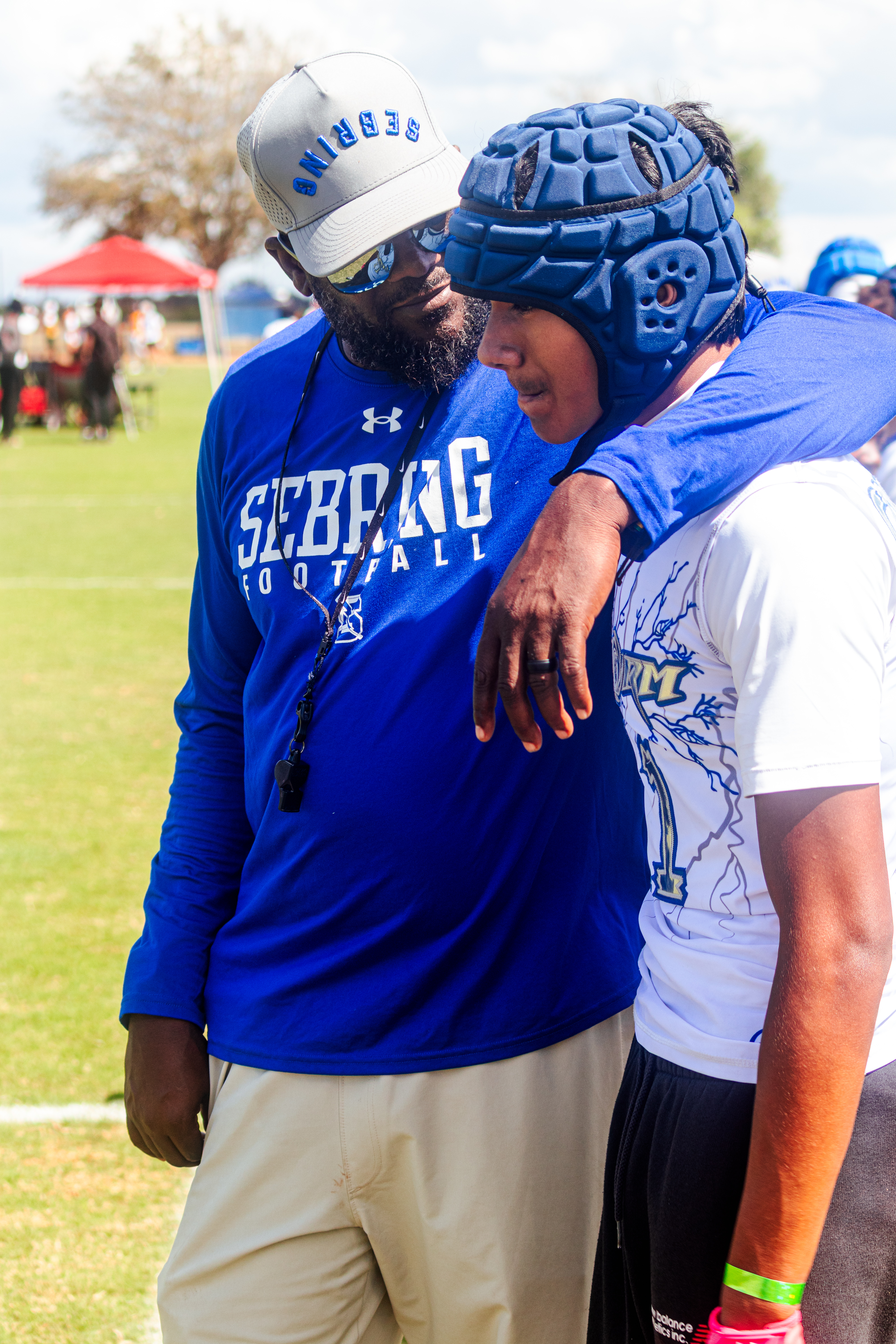 Coach speaking with player on the sideline